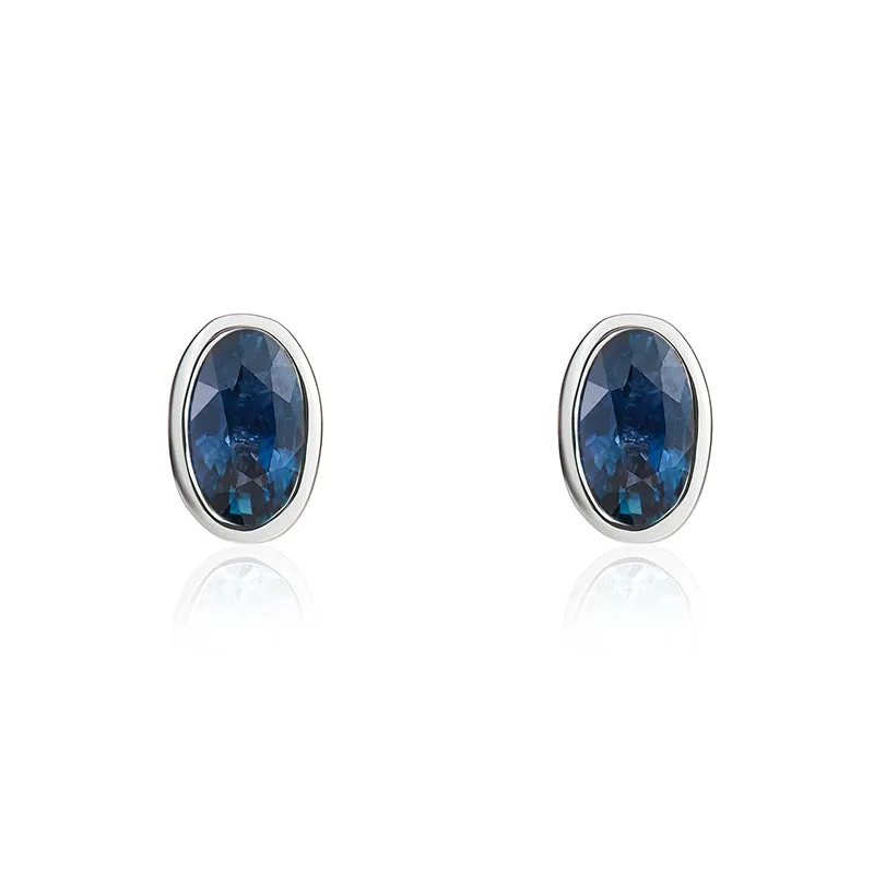 9ct White Gold Sapphire 5x3mm Oval Rub Over Set Stud Earrings